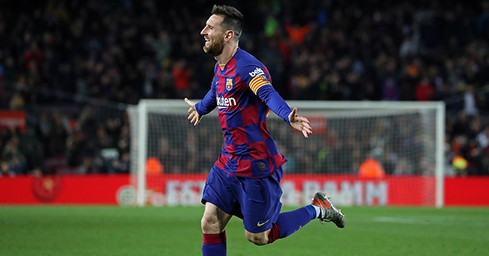 Messi hat-trick sends Barcelona top
