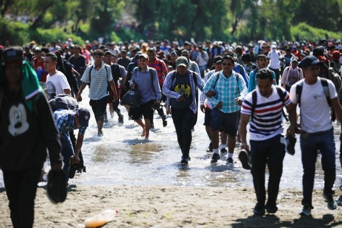 Hundreds of migrants wade river to reach Mexico