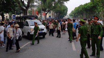 Vietnam says police arrest seven more from group accused of June police station bombing