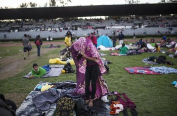 Caravan migrants arrive in Mexico City, bed down in stadium