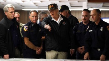 Trump sees wildfire areas, consoles those harmed by shooting