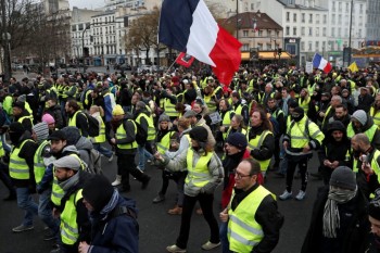 French 'yellow vests' march through Paris, keeping pressure on Macron