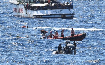 More than 10 jump overboard from migrant ship stranded off Italy
