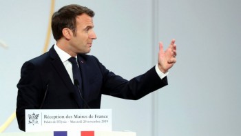 Macron defends job losses at symbolic blue collar factory