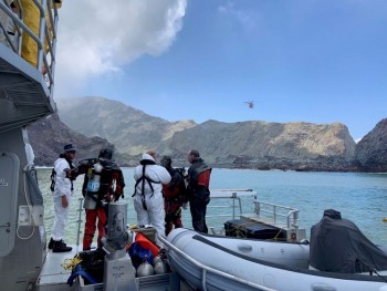 NZ recovery teams return to volcanic island; 1st victim identified